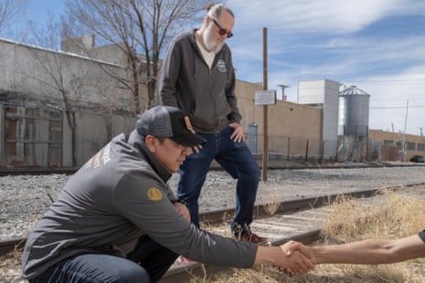 Isaiah Curtis and Sean Martin, Albuquerque community safety behavioral health responders, help a man in Albuquerque, New Mexico.