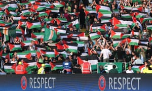 Celtic fans hold up Palestine flags.