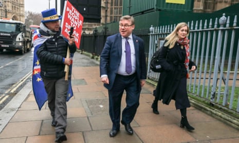 An anti-Brexit protester challenges Mark Francois outside parliament in London.