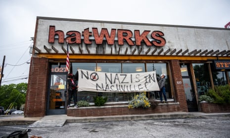 Protestors raise a sign in front of hatWRKS in Nashville, Tennessee on May 29.