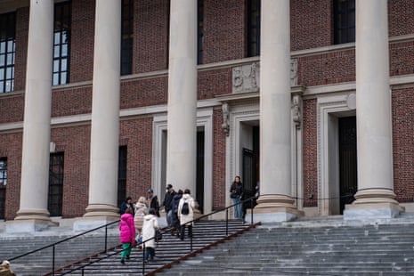 People walk up steps towards a door