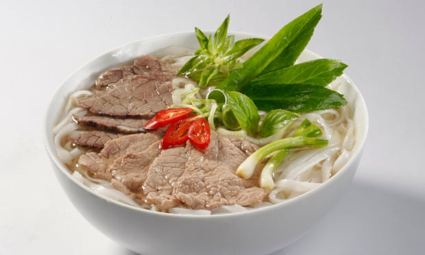 A plate of phở, a Vietnamese dish made up of rice noodles, beef, and fresh herbs.