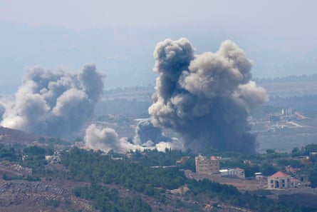 Aerial shot of smoke rising from villages