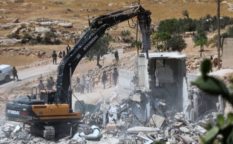 An Israeli excavator demolishes a Palestinian house in the town of Yatta, south of the West Bank city of Hebron, on May 28, 2025. Mideast Hebron Palestinian House Demolition - 28 May 2025