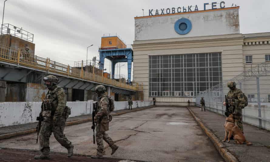 A picture taken during a media tour organized by the Russian Army shows Russian servicemen standing guard near the Kakhovka Hydroelectric Power Plant, near Kherson, Ukraine.