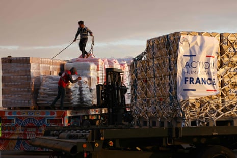 Egyptian Red Crescent members load humanitarian aid for Gaza brought by a French air force aircraft at El-Arish international airport in Egypt.