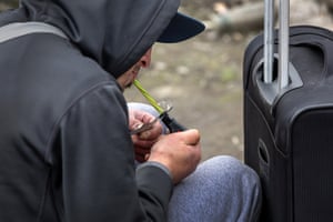 A homeless man, 24, smokes fentanyl.