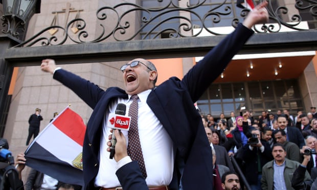 Egyptian lawyer Khaled Ali celebrates outside the courthouse in Cairo after the verdict
