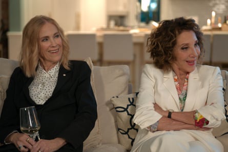 Two women sitting on a sofa, smiling