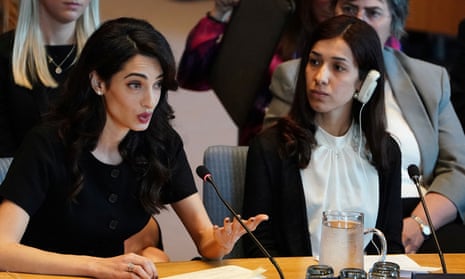 Nadia Murad listens as Amal Clooney speaks at the United Nations Security Council during a meeting about sexual violence in conflict in New York, New York, U.S., April 23, 2019. REUTERS/Carlo Allegri
