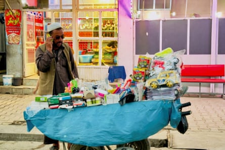 A street vendor speaks on his phone