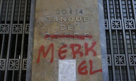 Graffiti covers a Bank of Greece sign making it read 'Bank of Merkel'