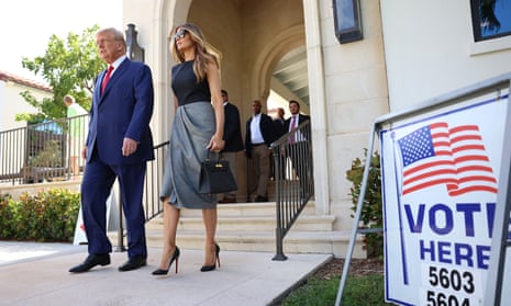 Donald and Melania Trump walk together after voting in Palm Beach, Florida.