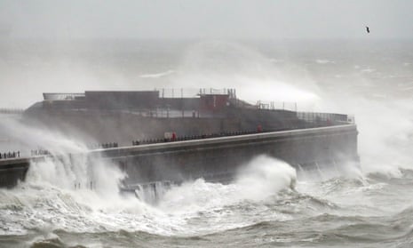 Waves crash over the harbour wall in Dover, Kent, on 14 January during Storm Brendan