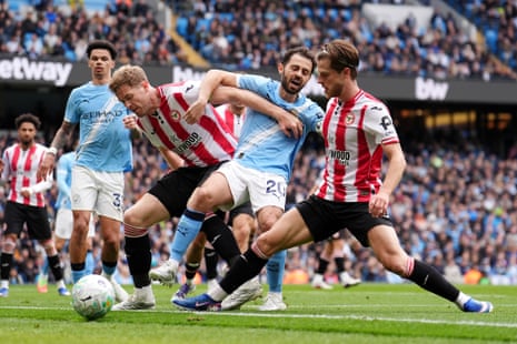 Bernardo Silva is crowded out by Nathan Collins and Mathias Jensen.