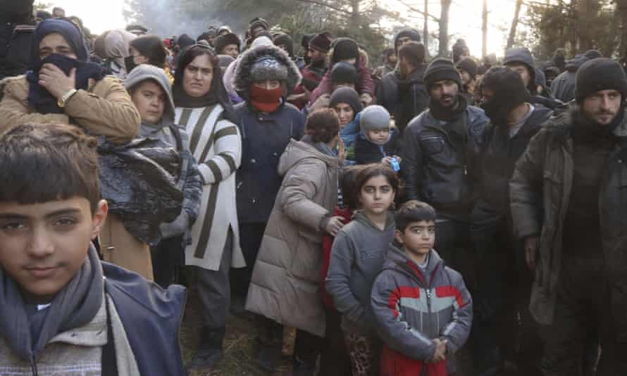 Migrants queue up to receive aid near Grodno, in Belarus, near the border with Poland.