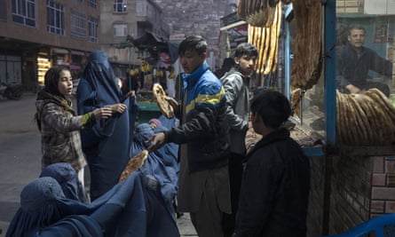 Food distribution outside a Kabul bakery at the end of last year