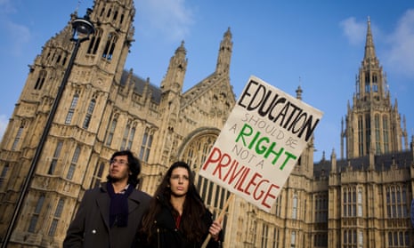 A student protests outside parliament in Westminster, against spending cuts, tuition fees and student debt. 