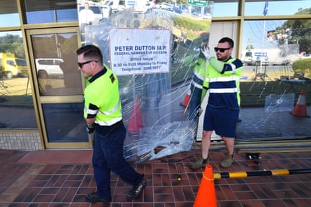 Workman remove damaged glass windows from the Queensland electorate office of Peter Dutton on 24 August 2018 after vandals hurled pavers amid Dutton’s bid to unseat Malcolm Turnbull.