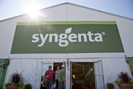 people walking out of a building displaying a Syngenta sign