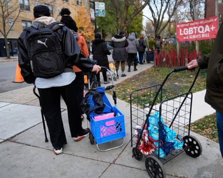 People queue to pick up donated food at the Care for Real Rogers Park location, Chicago, 13 November 2025.