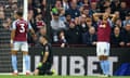 Aston Villa players and fans look dejected after a mistake by their keeper Emiliano Martinez (centre) gives Liverpool the lead in the second minute of the game.