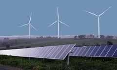 Solar panels with wind turbines in the background
