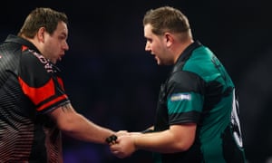 Adrian Lewis, left, congratulates Kevin Münch after the German’s shock victory at Alexandra Palace.