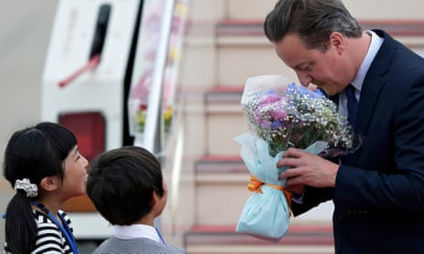 David Cameron accepts flowers as he arrives in Tokoname, Japan, for the G7 meeting.