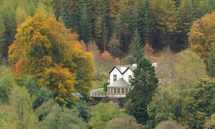 A white house surrounded by woodland
