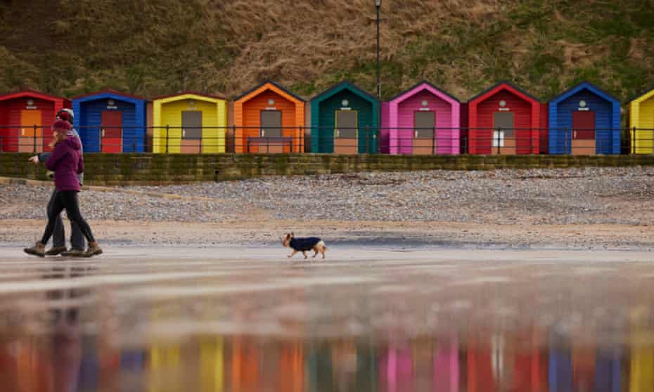 Dog walkers on the beach at Saltburn-by-the-Sea in North Yorkshire. Owners have recently reported a mystery illness affecting their dogs after exercising them along the Yorkshire coastline from South Gare to Bridlington. 