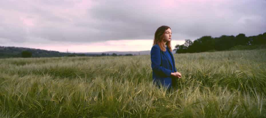 Schoolgirl Catriona Walsh stands in a barley field along the Irish border in Londonderry, Northern Ireland