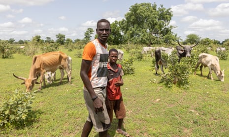 Herder Aliou Ndong, left, during the move south,  where he has found better grazing  for his cattle.