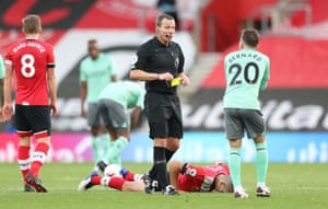 Bernard is shown a yellow card by referee Kevin Friend.