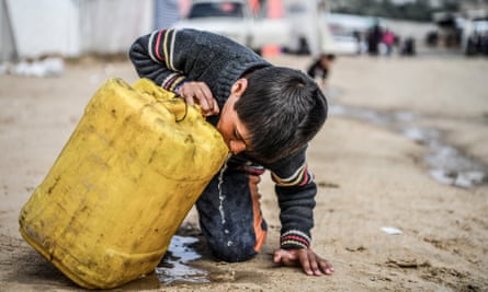 A child drinks from a plastic container in Gaza. More than 2 billion people lack access to safe drinking water.
