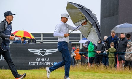 Ludvig Åberg puts up an umbrella at the Scottish Open