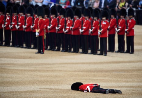 A Guardsman faints at Horseguards Parade for the annual Trooping the Colour ceremony
