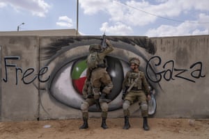 Soldiers conduct a mock assault. ‘Free Gaza’ graffiti adorns the walls