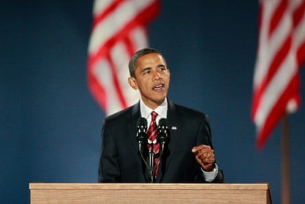 obama, a man in a suit, speaks in front of a microphone with hand gestured