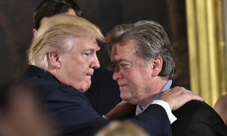 President Donald Trump (L) congratulating Senior Counselor to the President Stephen Bannon during the swearing-in of senior staff in the East Room of the White House 