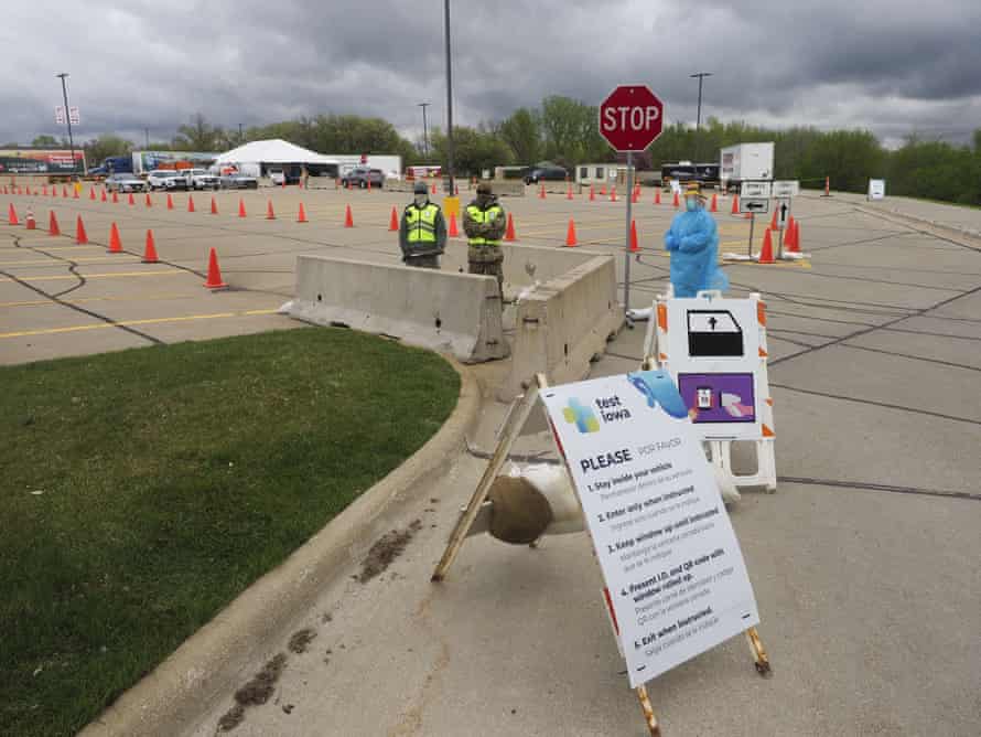 A healthcare worker waits for people to show up to a testing site in Sioux City.