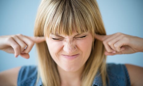 Woman blocking ears with fingers