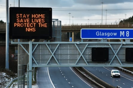 Sign on a gantry over the M8 motorway to Glasgow reads: Stay home, save lives, protect the NHS