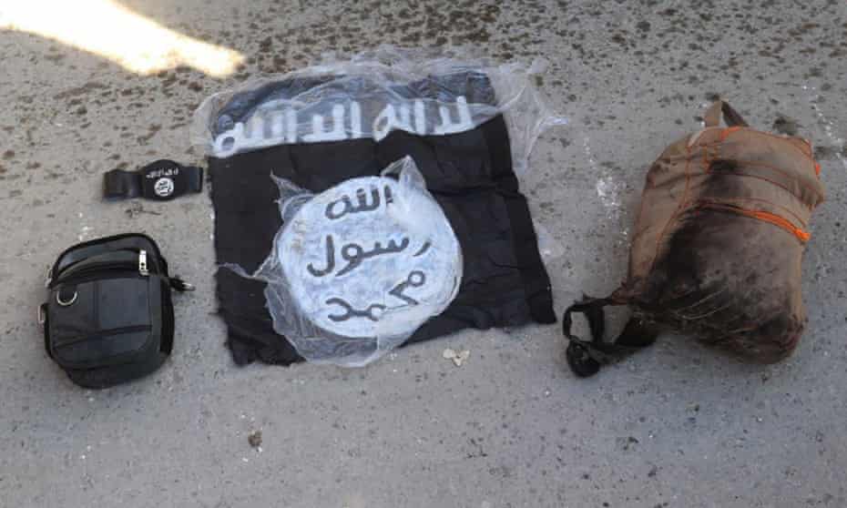 A flag and bags belonging to IS fighters who were arrested by the Kurdish-led Syrian Democratic Forces after they attacked Ghuwayran prison, in Hasakah, north-east Syria.