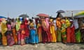 Women queue to vote in the current general election in the Darrang district of Assam.