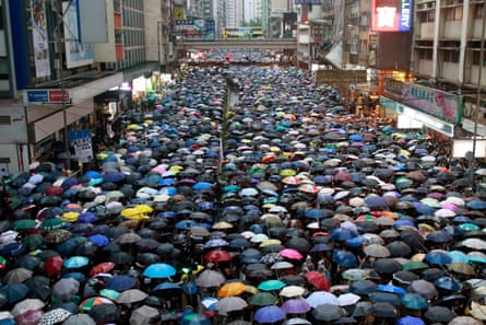 Hundreds of thousands of protesters dressed in black rally in Victoria Park in Hong Kong on Sunday.