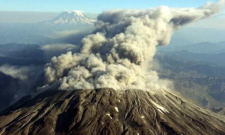 Mount St Helens erupts with steam, dust and ash 5 October 2004, in this photograph taken at 12,000 feet looking north. In the background is Mount Rainier.
