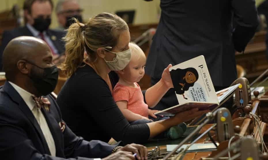 Buffy Wicks holding a book for  her daughter at the state capitol in July.