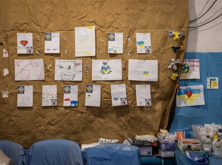 Drawings and messages of support are seen on the wall of a stabilisation centre.
