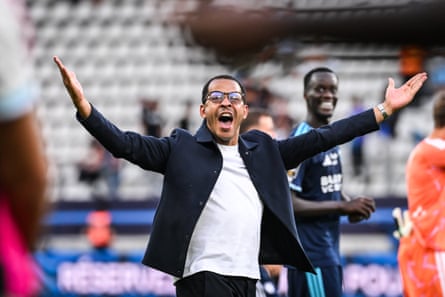 Liam Rosenior raises his arms in jubilation to celebrate victory in front of the Strasbourg supporters.